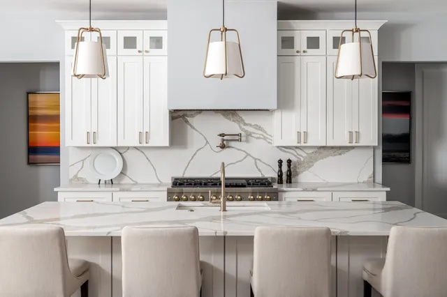 a kitchen with stainless steel appliances granite countertop a sink and a refrigerator