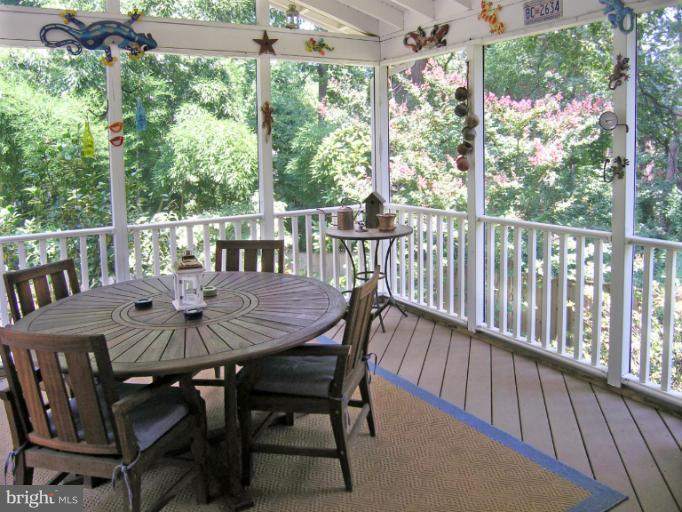 a view of a dining table and chairs on the roof deck