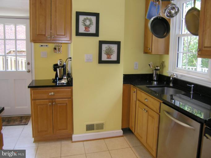 1705 Noyes Lane Silver Spring, MD 20910 - Photo 12 of 30 a kitchen with stainless steel appliances granite countertop a sink a stove and a refrigerator