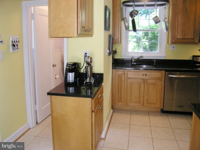 1705 Noyes Lane Silver Spring, MD 20910 - Photo 19 of 30 a kitchen with stainless steel appliances granite countertop a sink and a cabinets