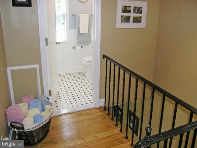 1705 Noyes Lane Silver Spring, MD 20910 - Photo 20 of 30 a view of a hallway with wooden floor and a bathroom