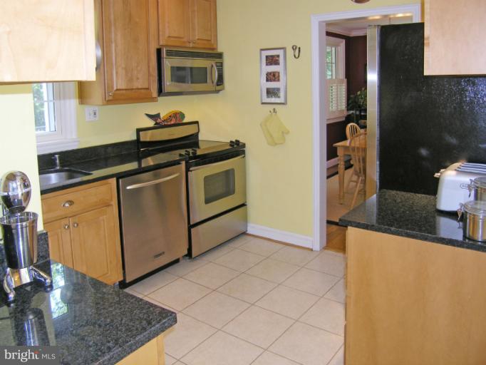 1705 Noyes Lane Silver Spring, MD 20910 - Photo 24 of 30 a kitchen with stainless steel appliances granite countertop a sink and a stove