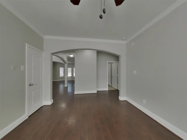 a view of a hallway with wooden shelves
