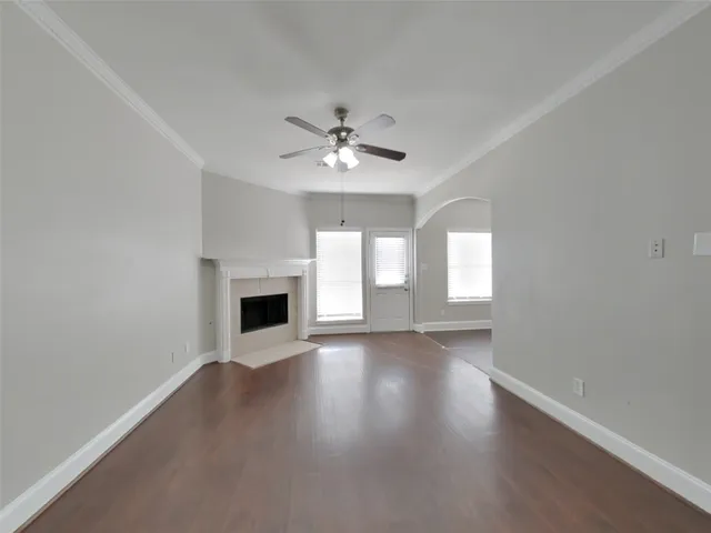a view of an empty room with a fireplace and a window