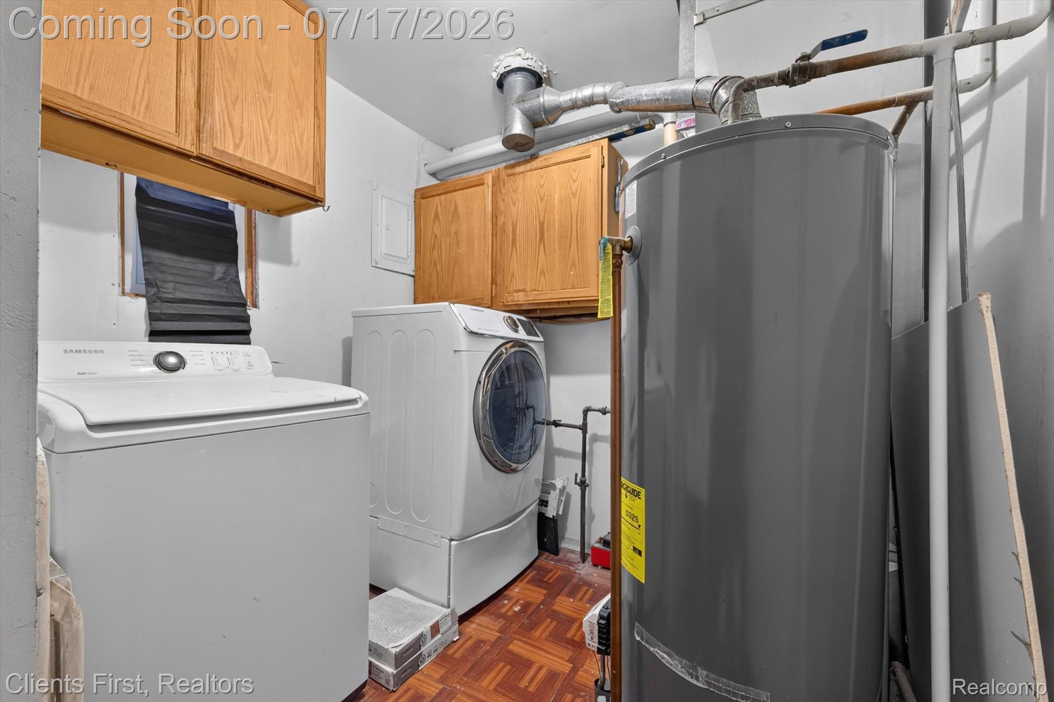 36852 Chase Street Romulus, MI 48174 - Photo 29 of 40 Utility space featuring a water heater, washer, and dryer
