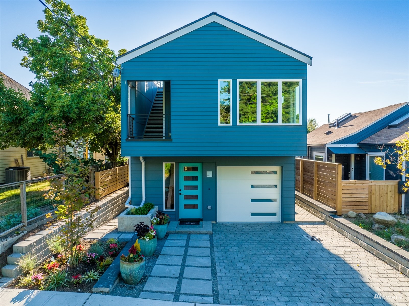 6525 Chapin Place North Seattle, WA 98103 - Photo 1 of 35 a front view of a house with a garden
