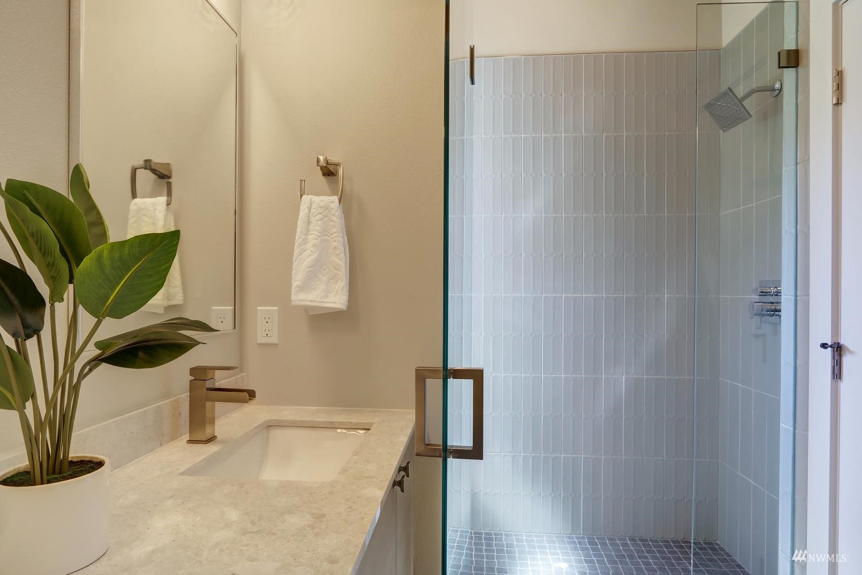 6525 Chapin Place North Seattle, WA 98103 - Photo 21 of 35 a bathroom with a sink a mirror and shower