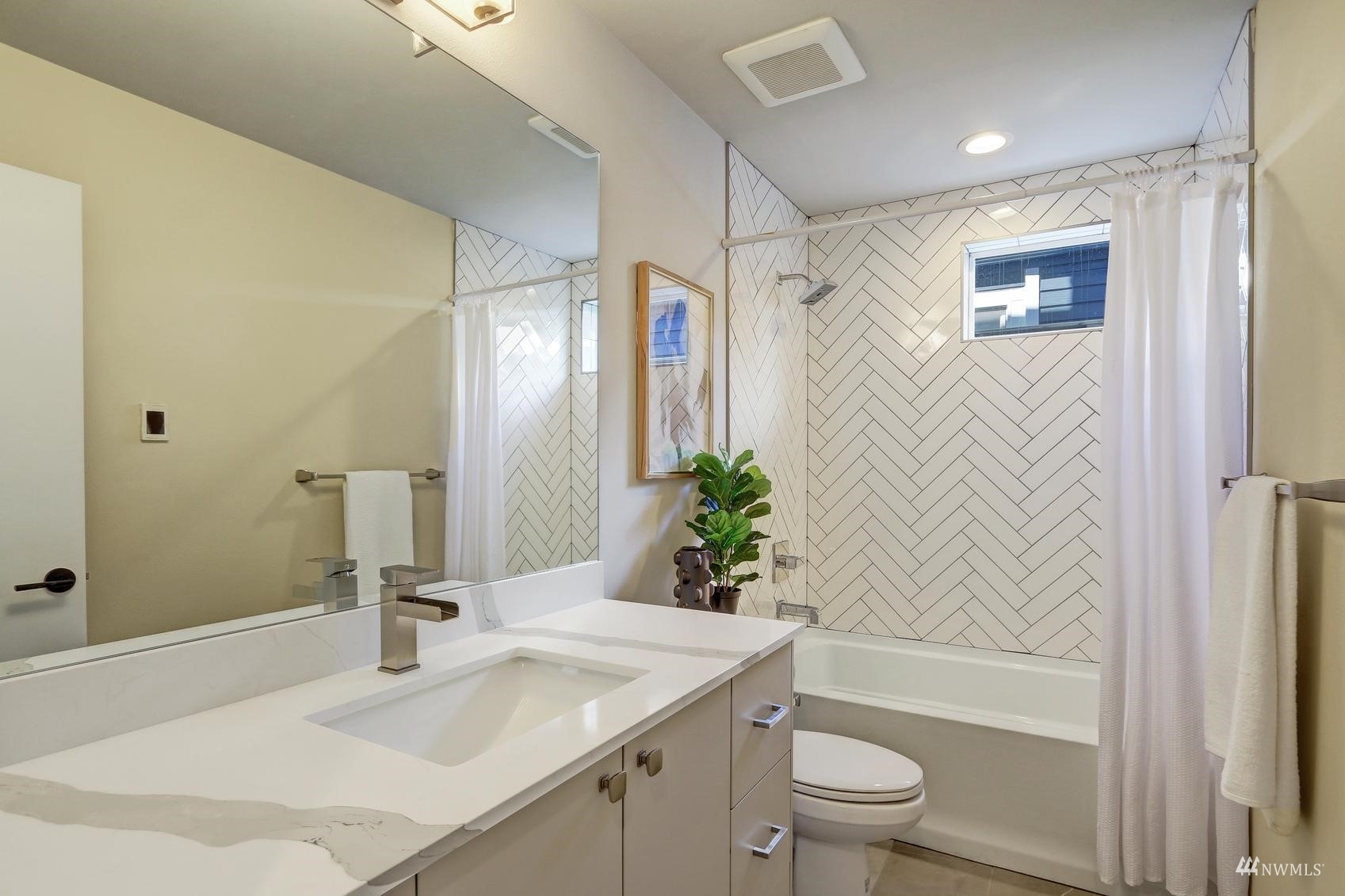 6525 Chapin Place North Seattle, WA 98103 - Photo 5 of 35 a bathroom with a granite countertop sink a toilet and shower