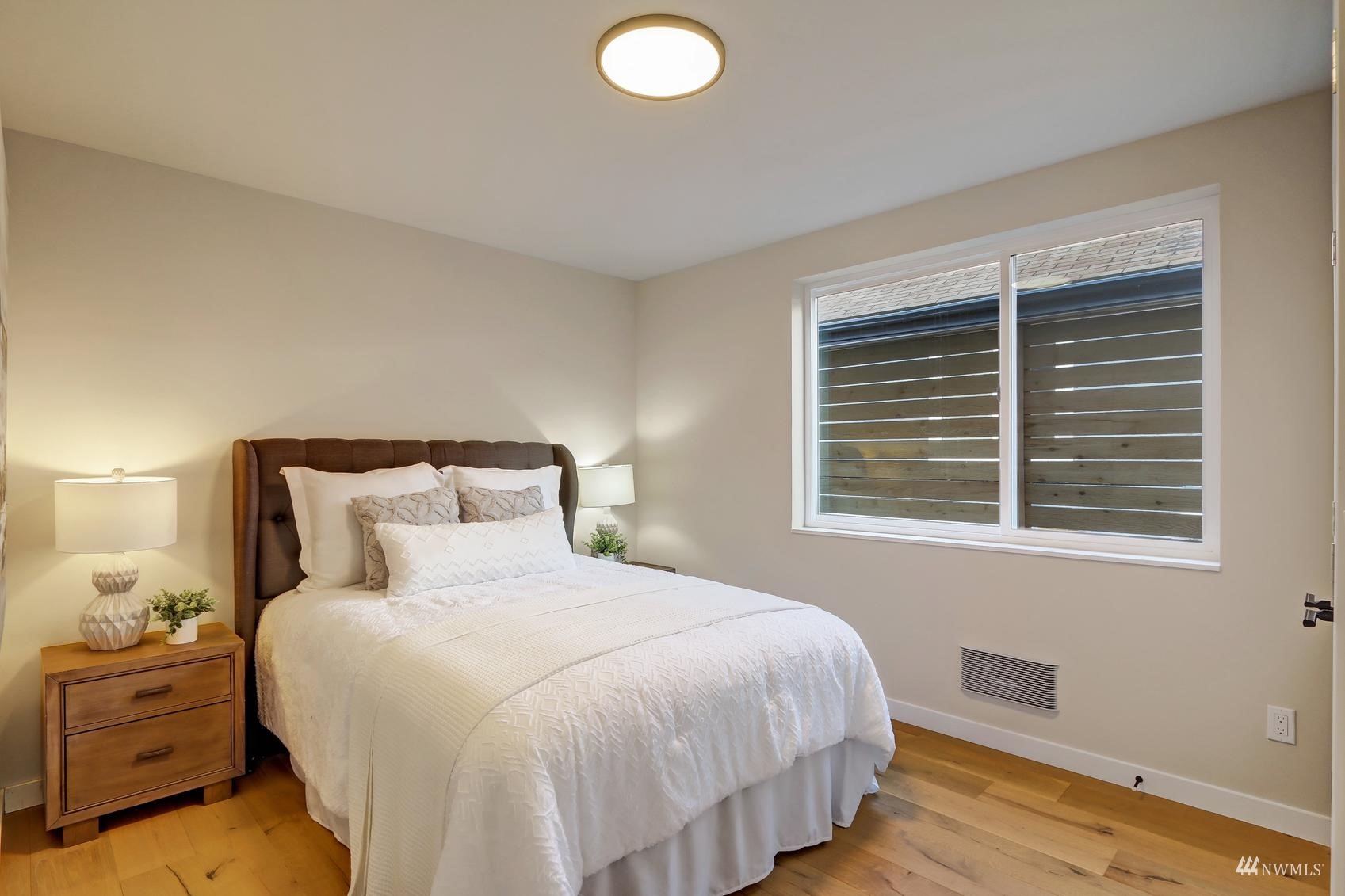 6525 Chapin Place North Seattle, WA 98103 - Photo 6 of 35 a bedroom with a bed and a window