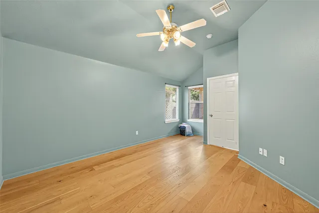 a spacious bathroom with a toilet sink and mirror