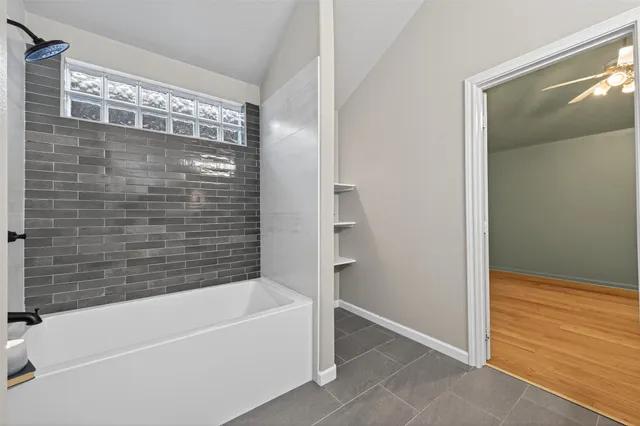 a bathroom with a bathtub and a shower
