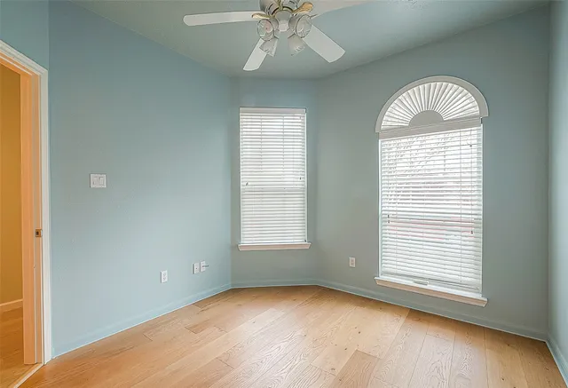 an empty room with wooden floor and closet