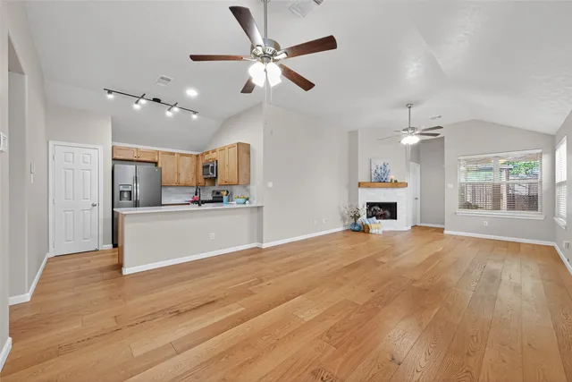 a kitchen with stainless steel appliances granite countertop a refrigerator stove top oven and sink