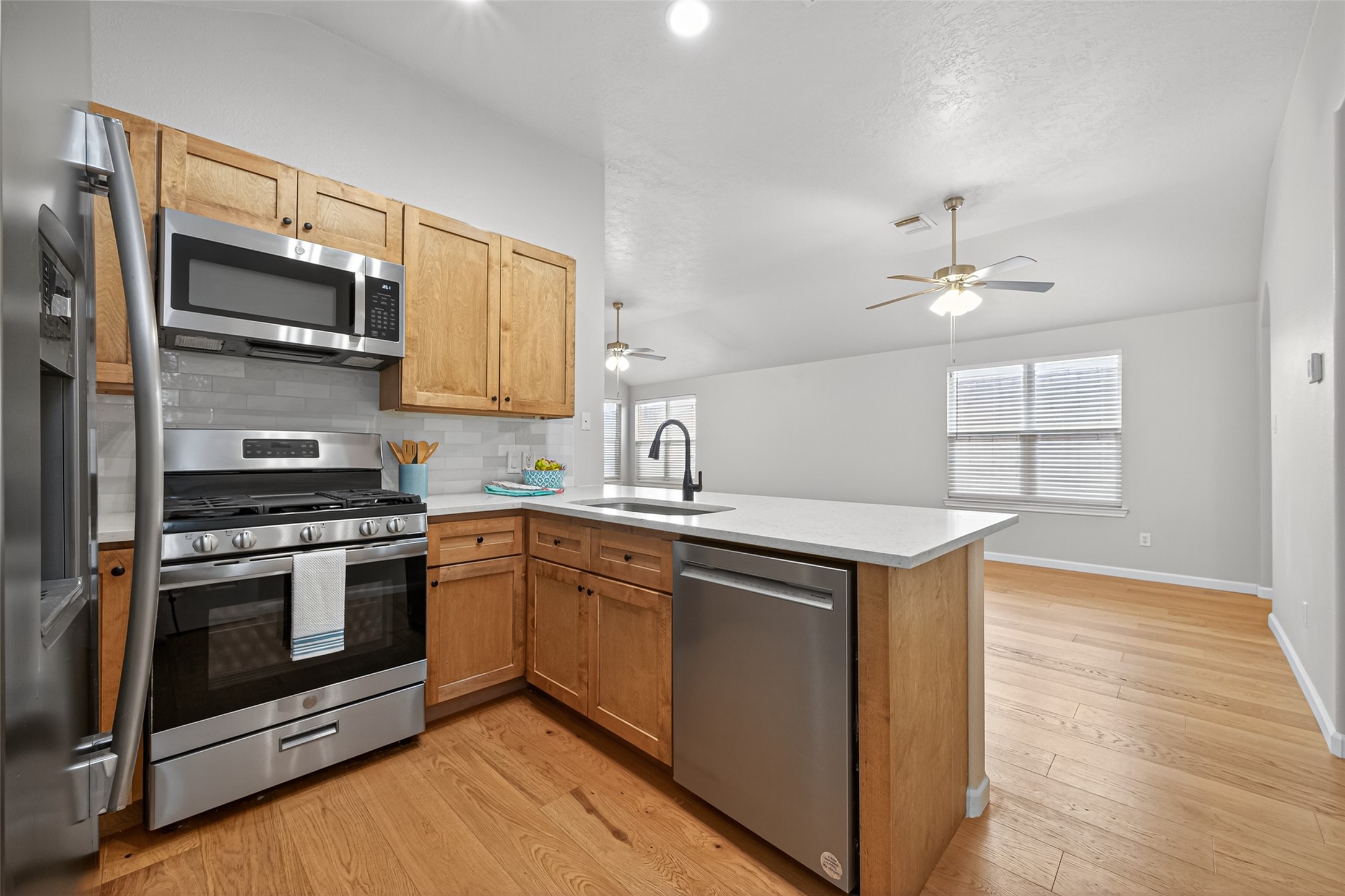 2910 Crescent Bend Road Spring, TX 77388 - Photo 5 of 35 a kitchen with stainless steel appliances a sink cabinets and wooden floor