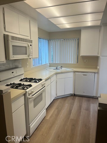 48 Clearbrook, Unit 56 Irvine, CA 92614 - Photo 2 of 6 a kitchen with granite countertop wooden cabinets stainless steel appliances and a sink