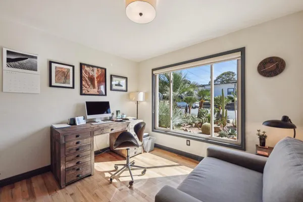 a work room with furniture and a large window