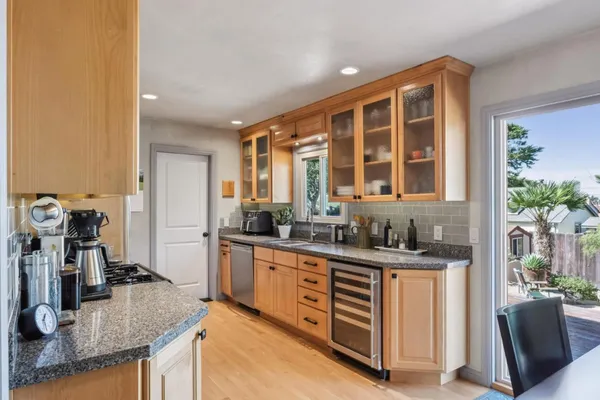 a kitchen with sink stove and cabinets