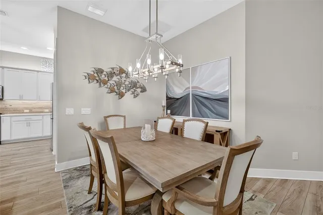 a view of a dining room with furniture and chandelier