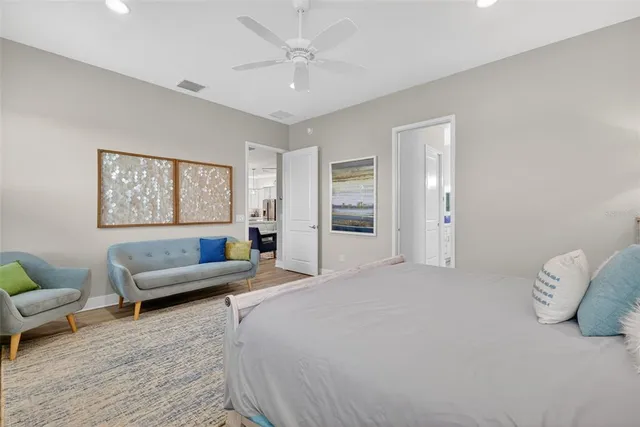 a bedroom with furniture and a large window