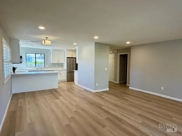 a view of a kitchen with a sink and a refrigerator