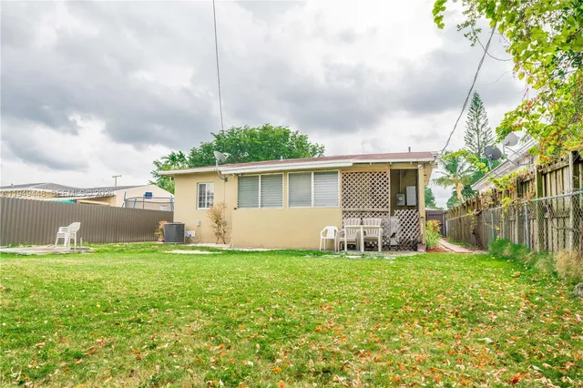 a view of a house with a yard and sitting area