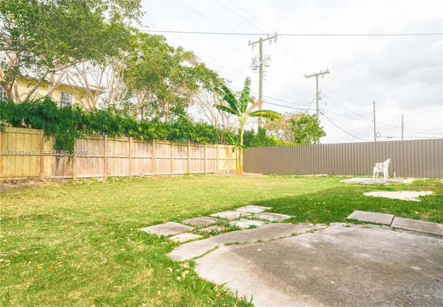 a view of a yard with a fence
