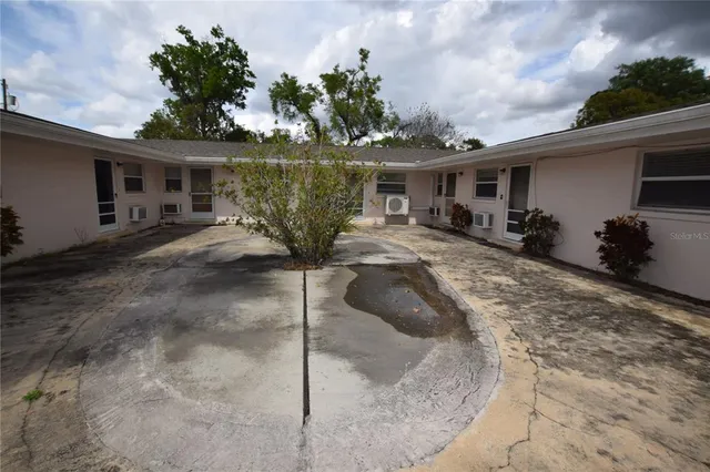 a front view of house with yard outdoor seating and barbeque oven