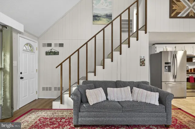 a kitchen with granite countertop a refrigerator stove and sink