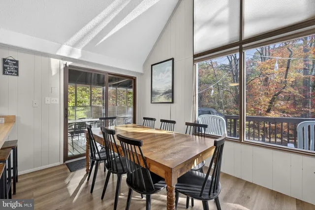 a living room with furniture large window and flat screen tv