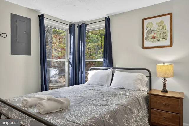 a bedroom with furniture and a wooden floor