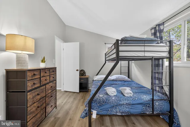 a roof deck with wooden fence and a bench