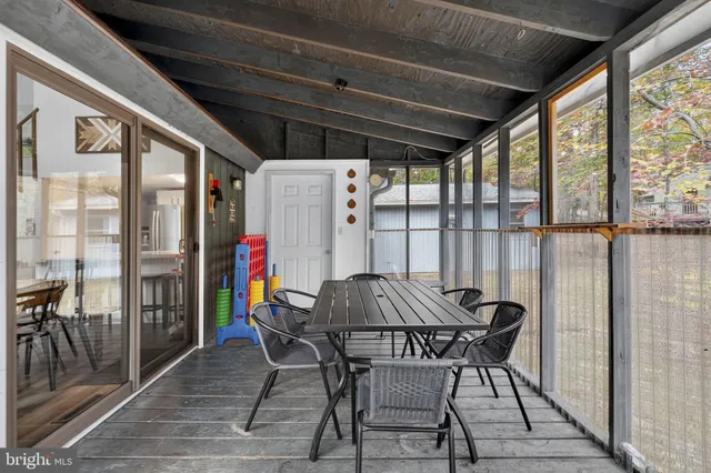 a view of a bedroom with a bed and glass door