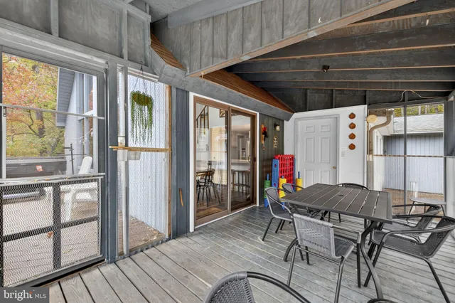 a view of a balcony with two chairs and a wooden floor