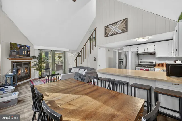 a living room with a fireplace and a floor to ceiling window
