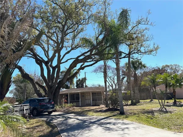 a view of a house with a tree in front