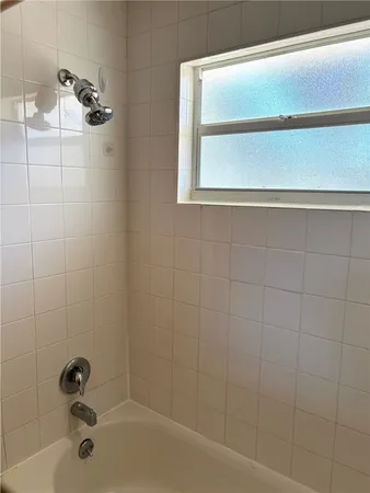 a view of a livingroom with a ceiling fan and window