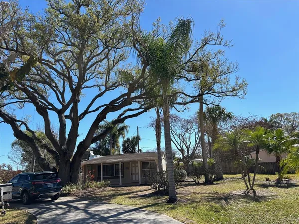 an aerial view of a house with a tree
