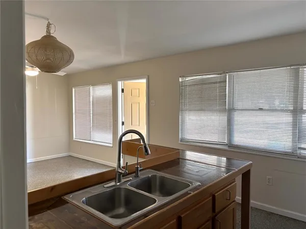 a kitchen with a sink a counter space and a window