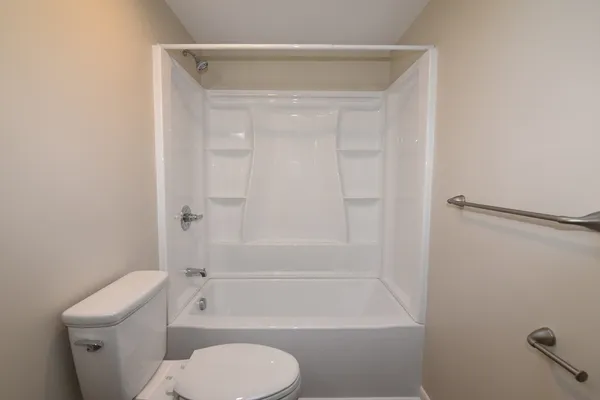 a bathroom with a toilet and shower