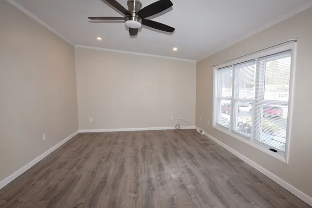 wooden floor in an empty room with a window
