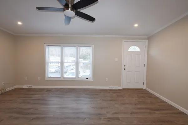 wooden floor in an empty room with a window
