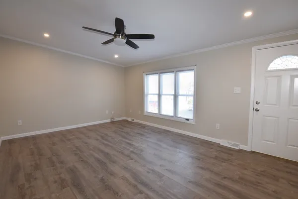 wooden floor in an empty room with a window