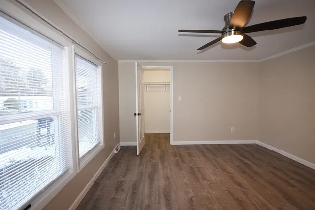 a view of a hallway with wooden floor