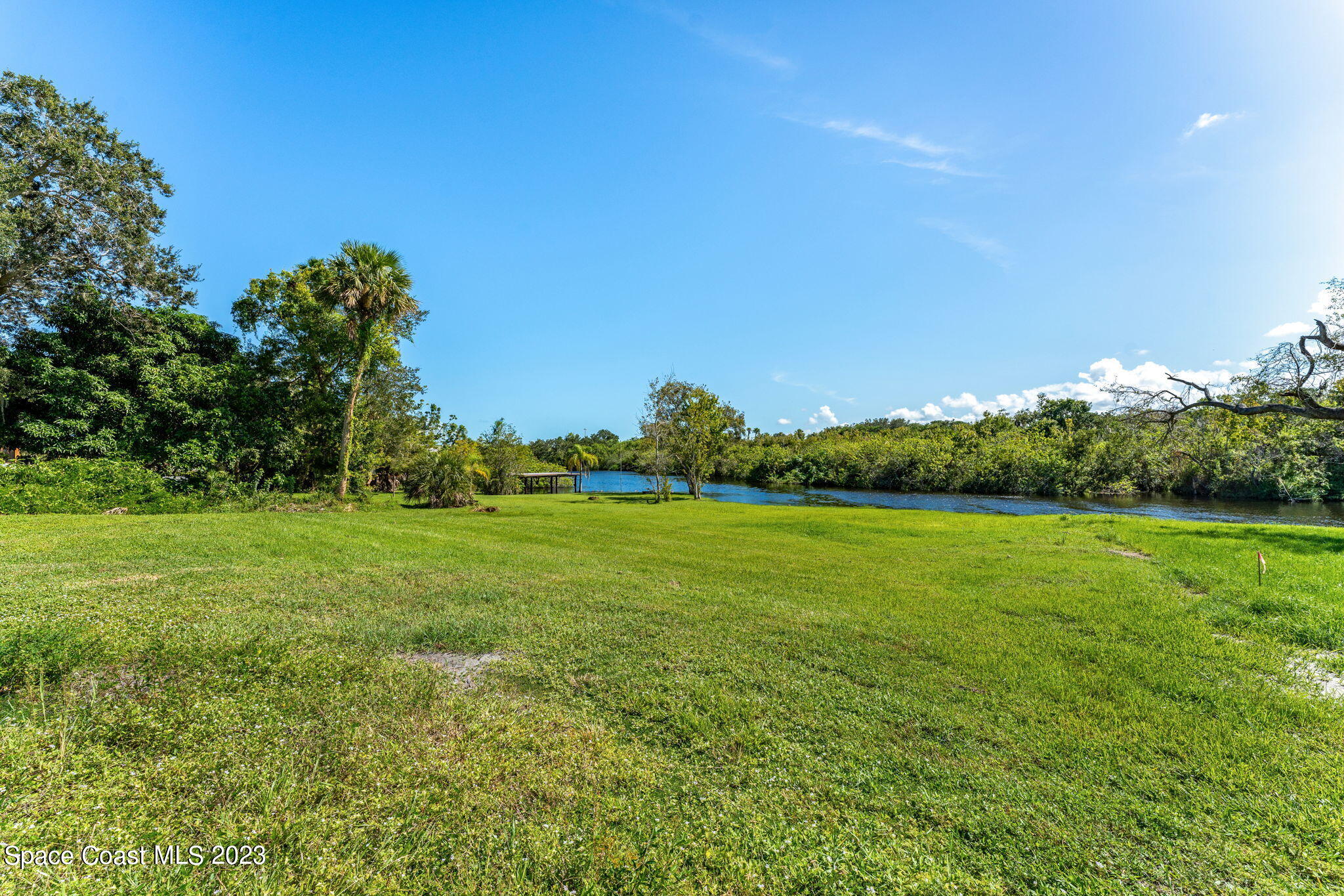 409 Roxy Avenue Melbourne, FL 32901 - Photo 25 of 31 a view of a field of grass and trees