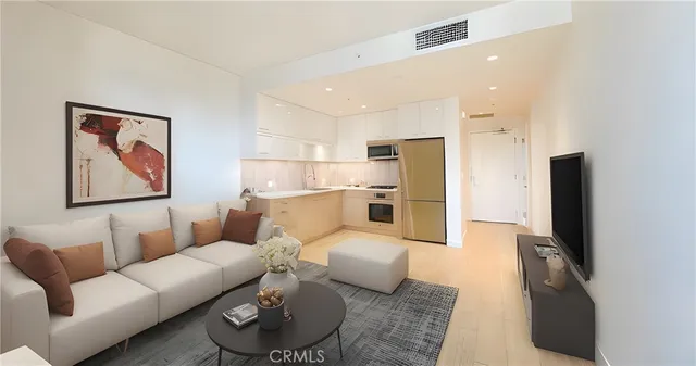 a living room with furniture a refrigerator and kitchen view