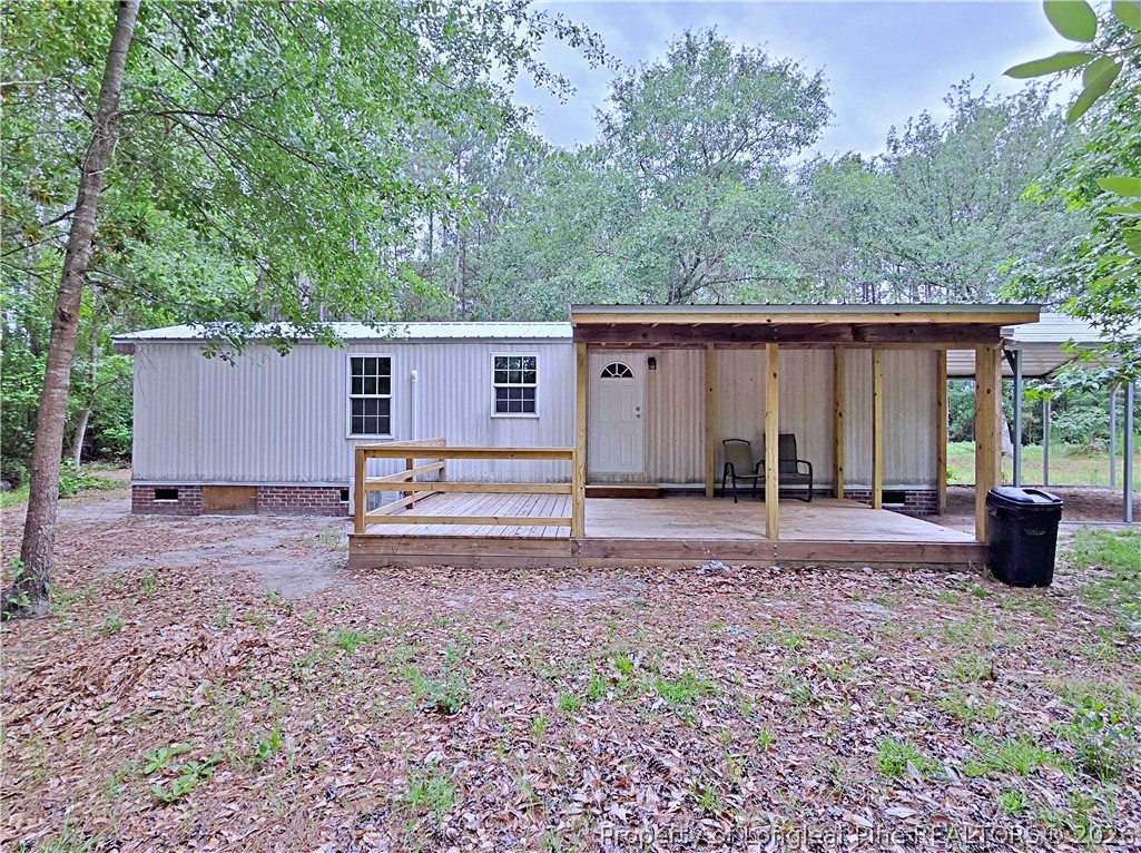 1031 Pine Acres Road White Oak, NC 28399 - Photo 27 of 29 a backyard of a house with wooden fence and a tree