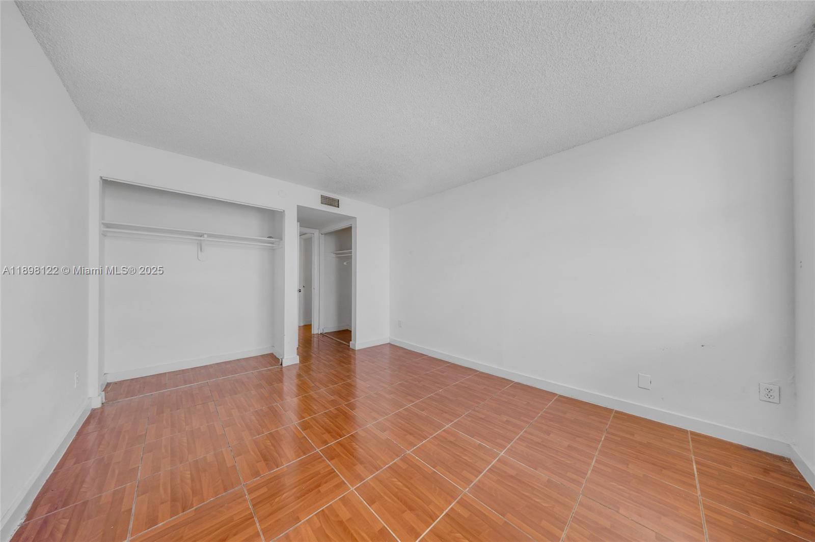 492 Northwest 165th Street, Unit C512 Miami, FL 33169 - Photo 14 of 27 a view of an empty room with wooden floor