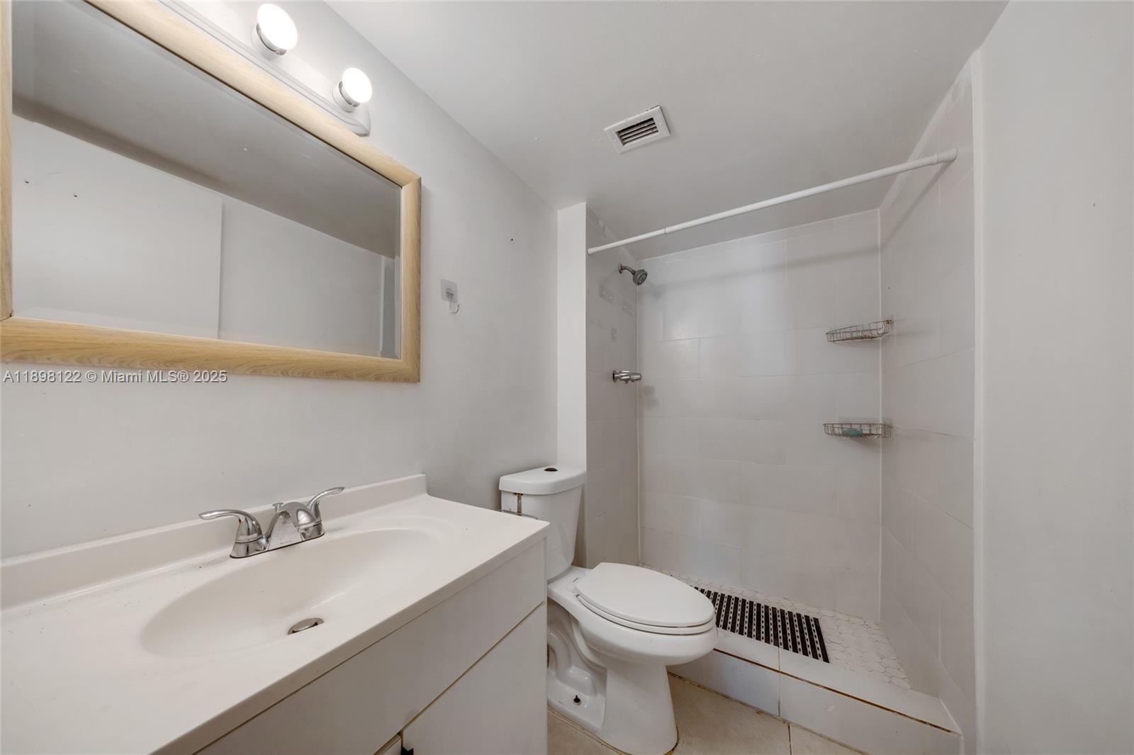 492 Northwest 165th Street, Unit C512 Miami, FL 33169 - Photo 15 of 27 a bathroom with a sink a toilet and shower