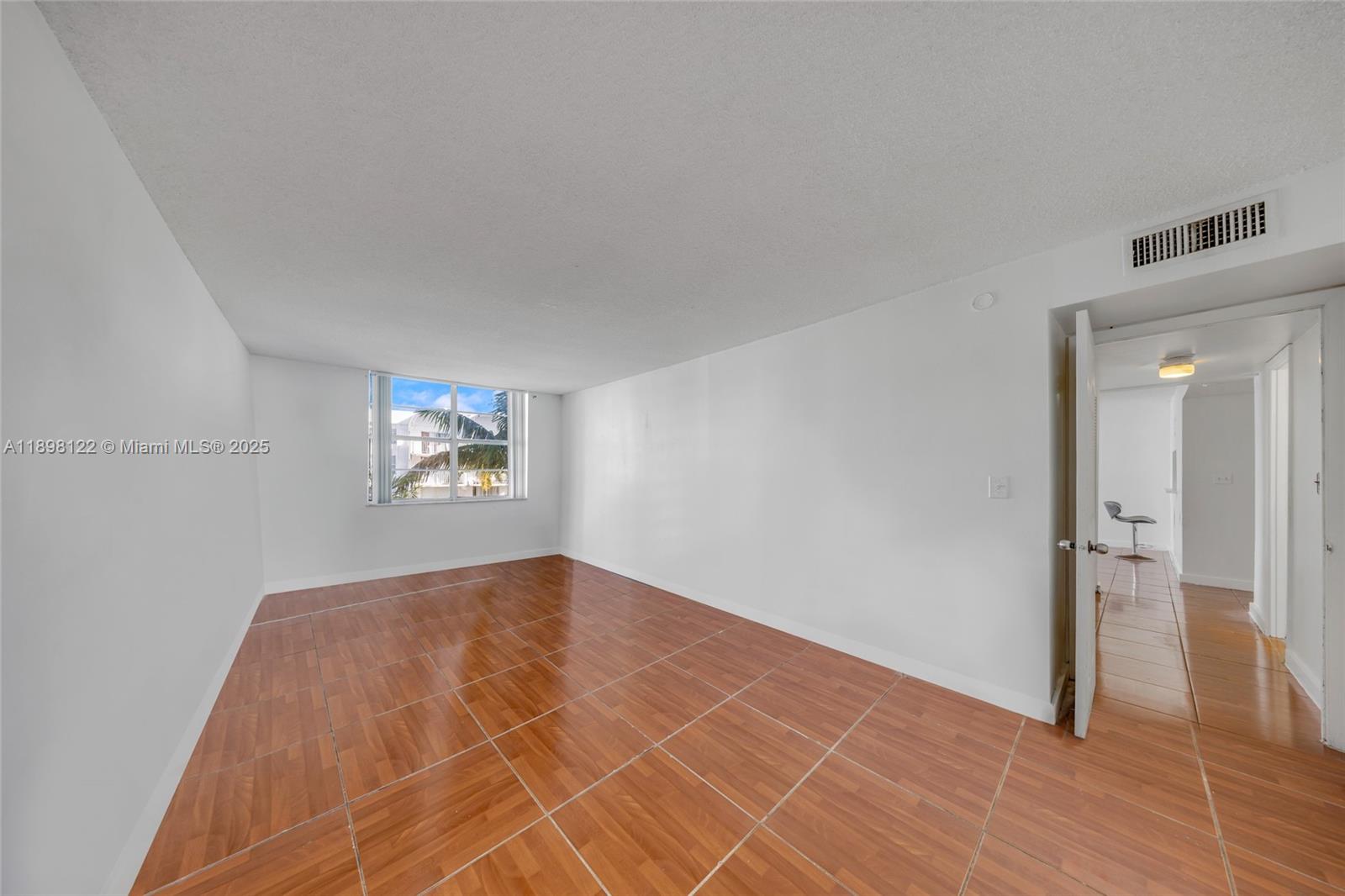 492 Northwest 165th Street, Unit C512 Miami, FL 33169 - Photo 17 of 27 a view of a livingroom with wooden floor and a kitchen space