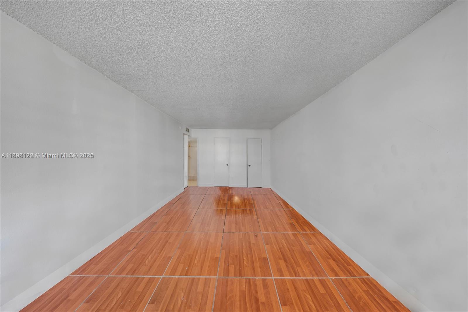 492 Northwest 165th Street, Unit C512 Miami, FL 33169 - Photo 18 of 27 a view of empty room with wooden floor